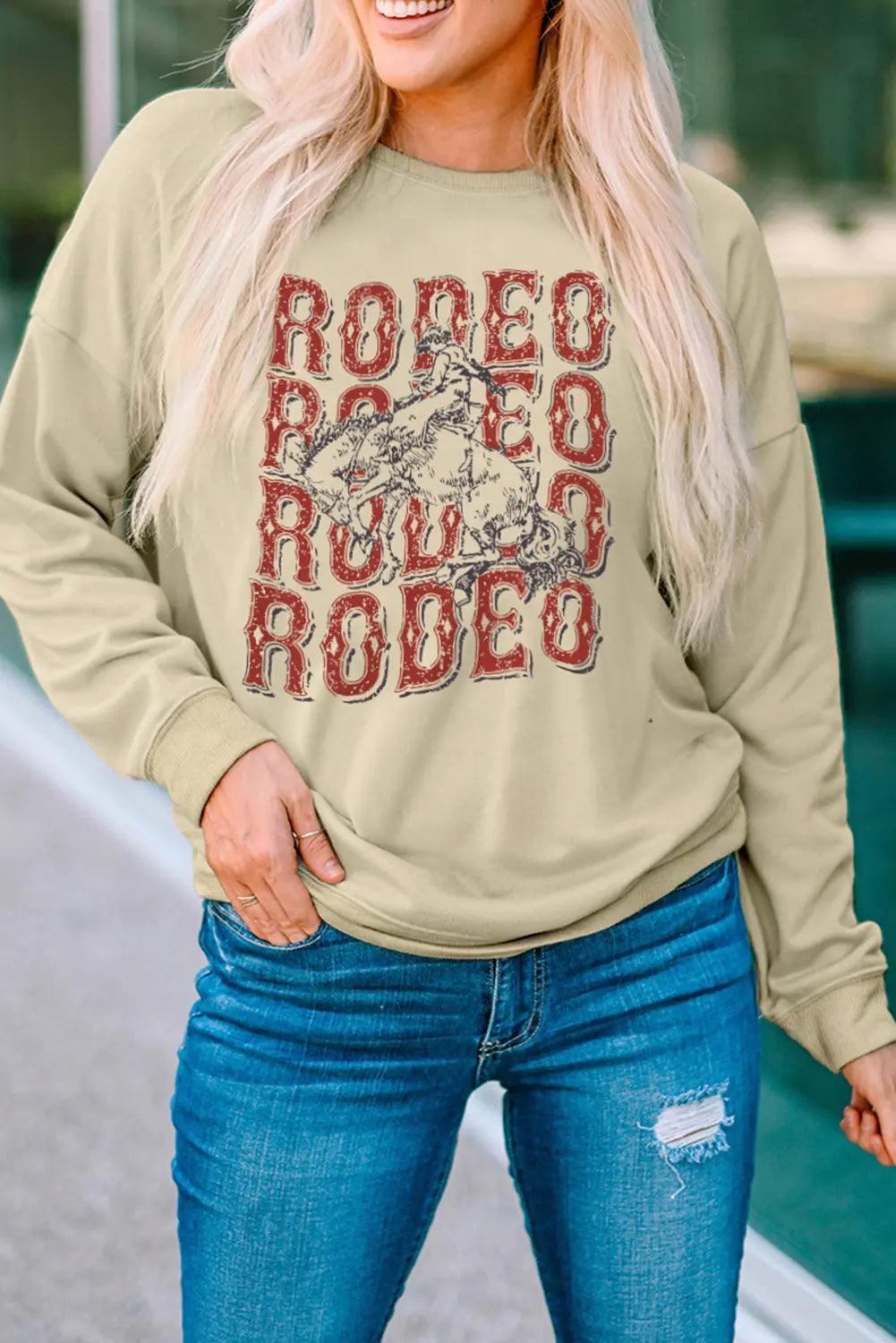 Round Neck Dropped Shoulder RODEO Graphic Sweatshirt - Elena Rae Co.