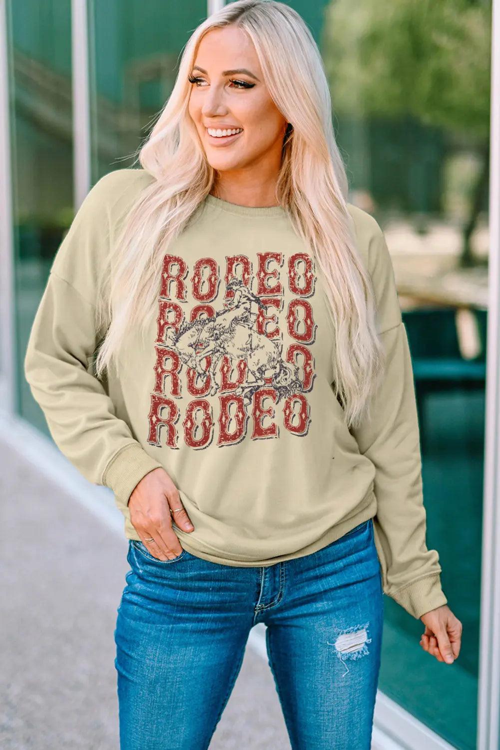 Round Neck Dropped Shoulder RODEO Graphic Sweatshirt - Elena Rae Co.